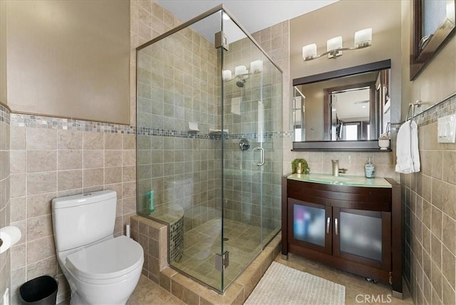 full bath featuring a shower stall, tile walls, and tile patterned floors