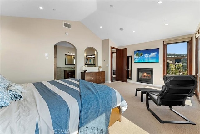 bedroom with lofted ceiling, recessed lighting, light carpet, visible vents, and a glass covered fireplace