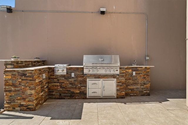 view of patio / terrace with a sink, exterior kitchen, and area for grilling