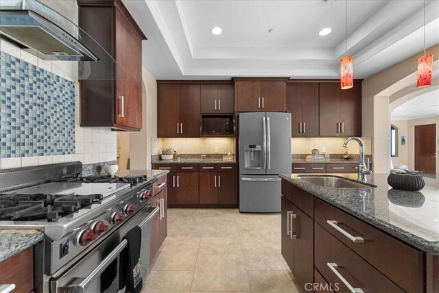 31422 Ceanothus Dr, Laguna Beach, CA 92651 - kitchen with stainless steel appliances, ventilation hood, hanging light fixtures, backsplash, and dark stone countertops