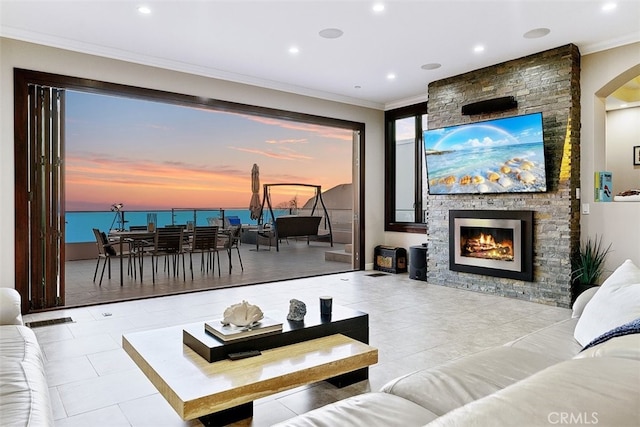 31422 Ceanothus Dr, Laguna Beach, CA 92651 - tiled living area with ornamental molding, a stone fireplace, recessed lighting, and arched walkways