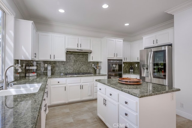 kitchen featuring a center island, crown molding, stainless steel appliances, a sink, and under cabinet range hood