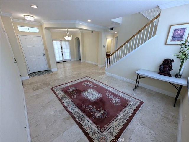 entryway with arched walkways, ornamental molding, stairway, and baseboards