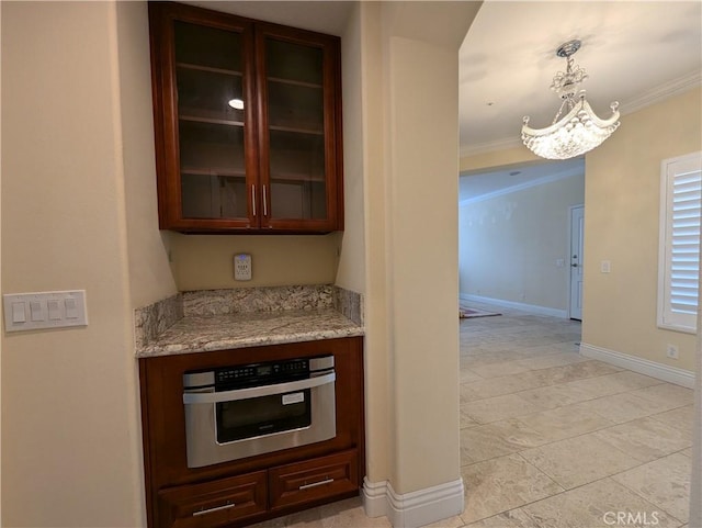 kitchen with light stone counters, crown molding, glass insert cabinets, stainless steel oven, and baseboards