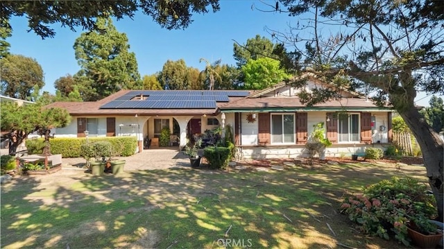 ranch-style home with solar panels