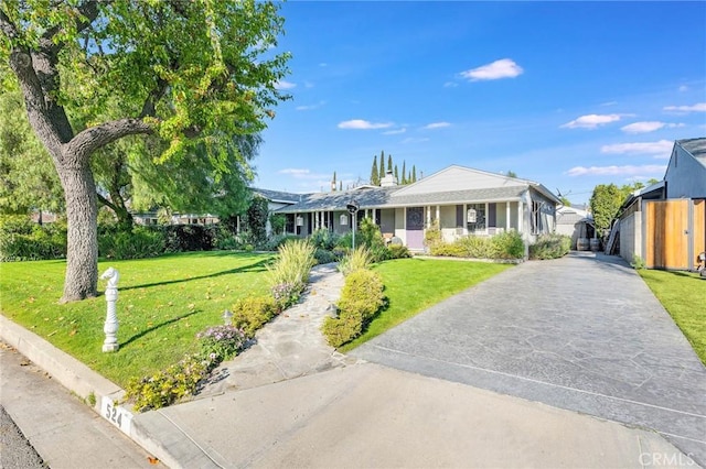 single story home with driveway and a front lawn