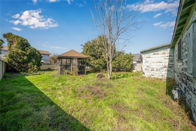 view of yard with an outdoor structure, exterior structure, and fence