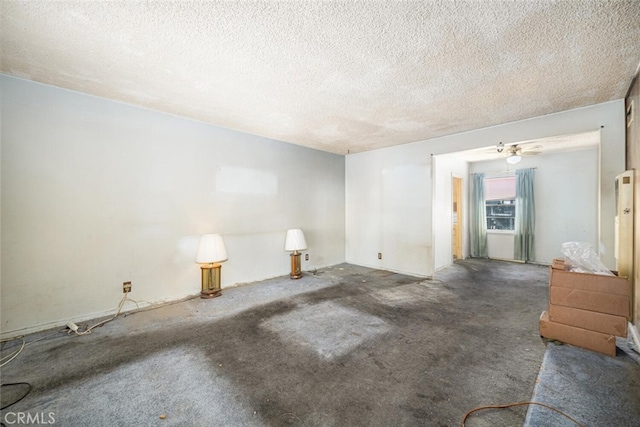 unfurnished room with a textured ceiling