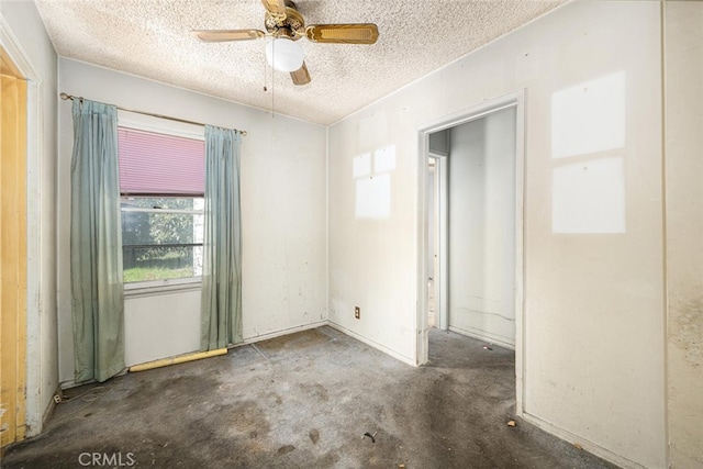 spare room featuring a textured ceiling and ceiling fan