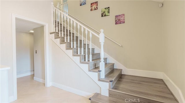 staircase featuring baseboards
