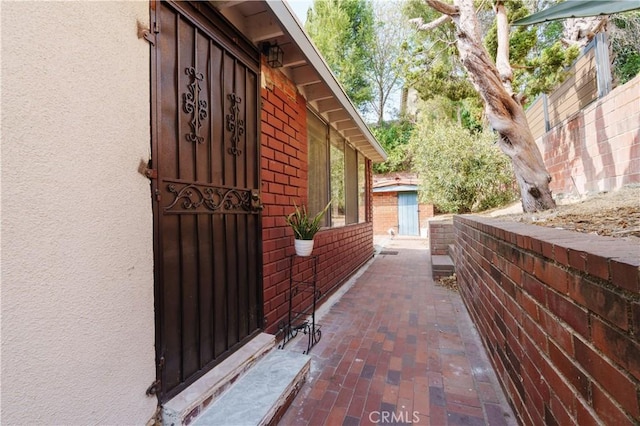 view of home's exterior with fence and brick siding