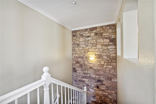 interior space with ornamental molding and an upstairs landing