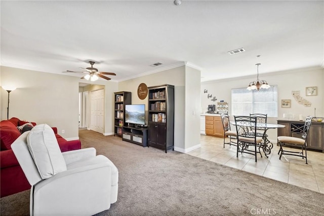 living room featuring light tile patterned floors, light carpet, ceiling fan with notable chandelier, visible vents, and crown molding