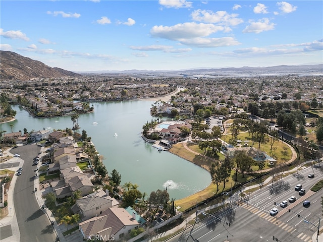 drone / aerial view featuring a residential view and a water and mountain view