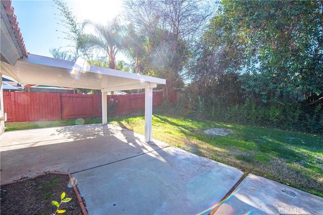 view of patio / terrace featuring a carport and fence