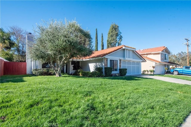 view of front facade featuring concrete driveway, an attached garage, a front lawn, and fence