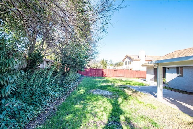 view of yard with a fenced backyard and a patio