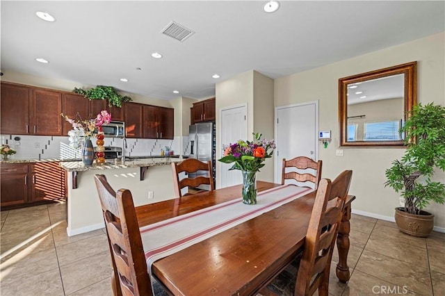 dining area featuring recessed lighting, visible vents, and light tile patterned floors