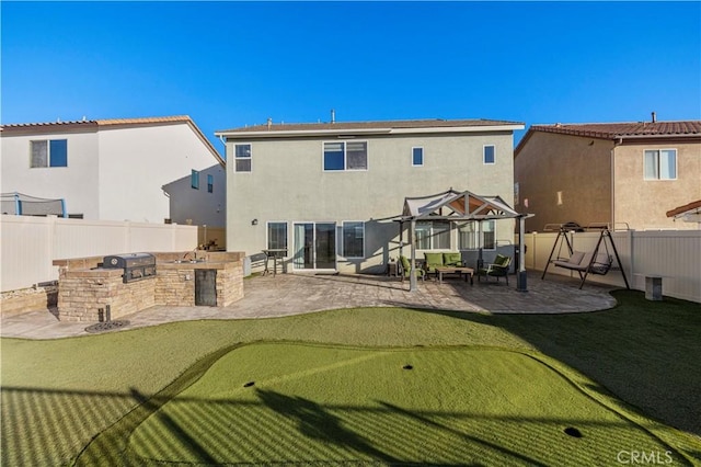 back of house with a fenced backyard, a patio, area for grilling, and stucco siding