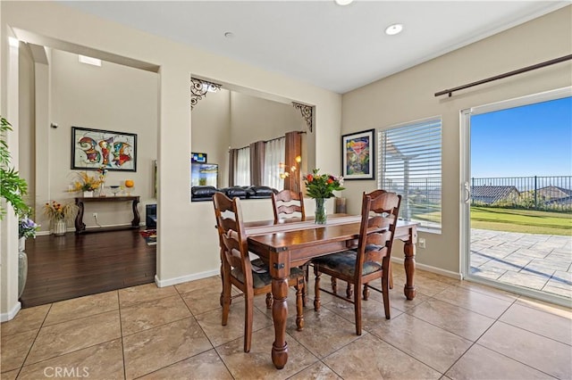 dining room featuring light tile patterned floors and baseboards