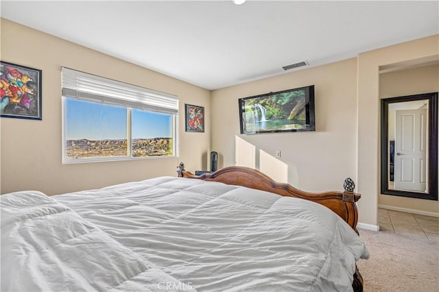 bedroom featuring light carpet, baseboards, and visible vents