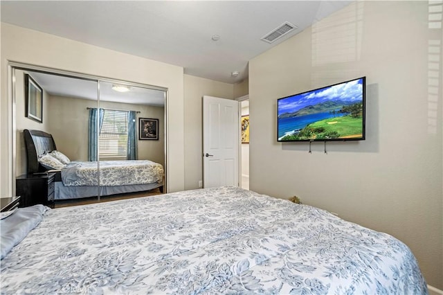 bedroom with a closet and visible vents