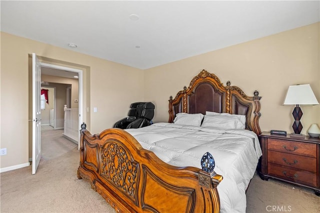 bedroom featuring light colored carpet and baseboards