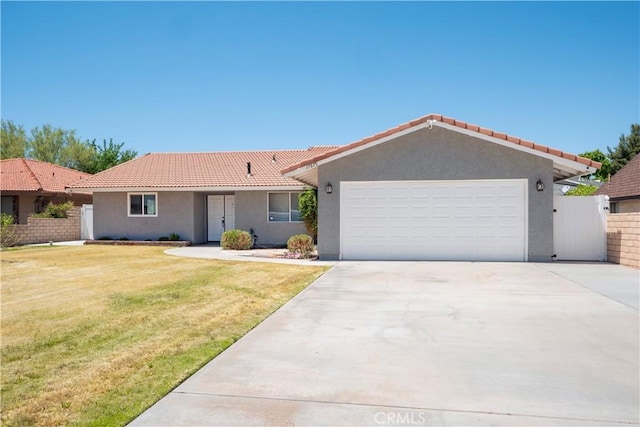 17875 Idyllwild Ln, Victorville, CA 92395 - ranch-style home with stucco siding, a tile roof, a garage, and driveway