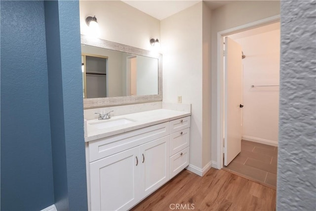 17875 Idyllwild Ln, Victorville, CA 92395 - bathroom with wood finished floors, vanity, and baseboards