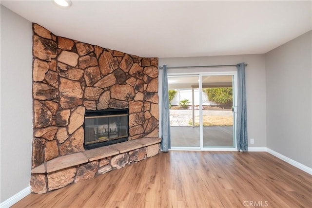 17875 Idyllwild Ln, Victorville, CA 92395 - unfurnished living room with a fireplace, baseboards, and wood finished floors