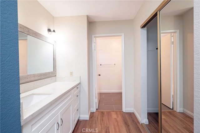 17875 Idyllwild Ln, Victorville, CA 92395 - bathroom featuring wood finished floors, vanity, and baseboards