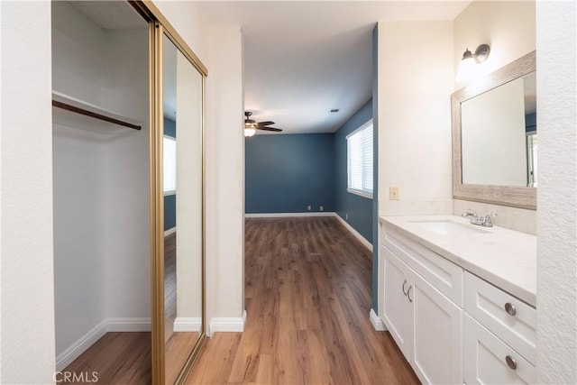 17875 Idyllwild Ln, Victorville, CA 92395 - bathroom with wood finished floors, a ceiling fan, vanity, and baseboards