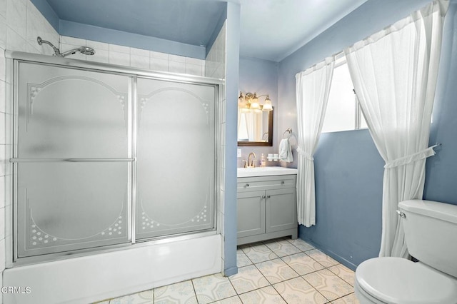 bathroom with bath / shower combo with glass door, vanity, toilet, and tile patterned floors