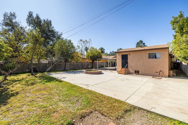 view of yard featuring entry steps, a patio area, and a fenced backyard