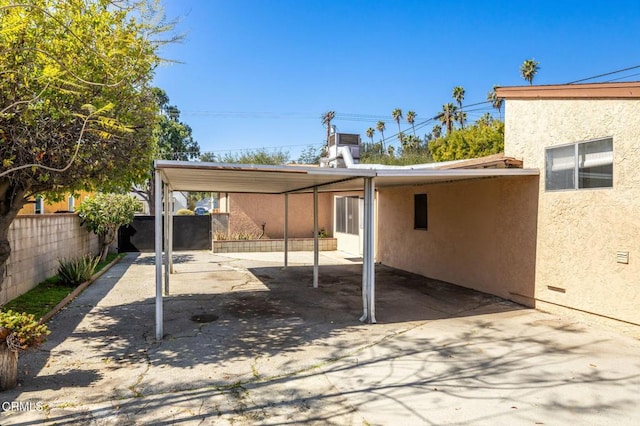 view of patio / terrace featuring a carport and fence