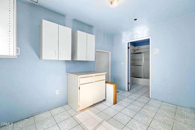 kitchen with light countertops and white cabinets