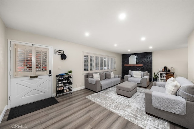 living room with recessed lighting, baseboards, and wood finished floors