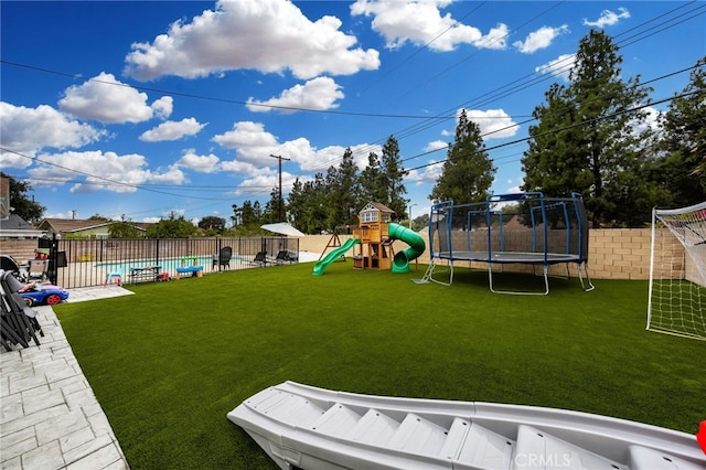 view of jungle gym with a trampoline, a fenced in pool, a fenced backyard, and a lawn