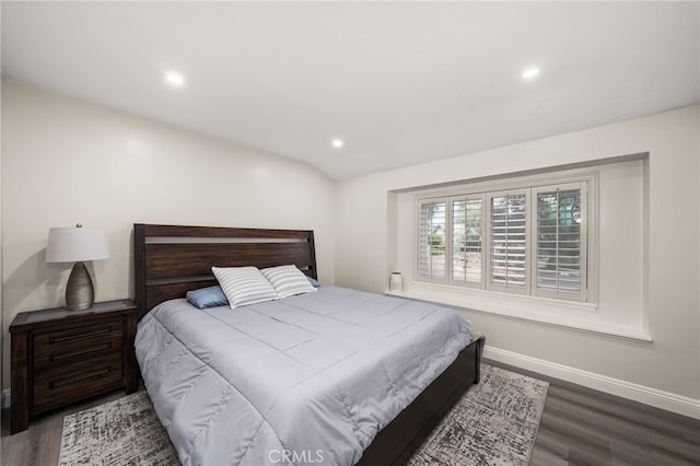 bedroom featuring baseboards, wood finished floors, and recessed lighting