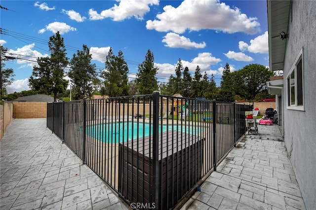 view of swimming pool with a patio area, a fenced backyard, and a fenced in pool