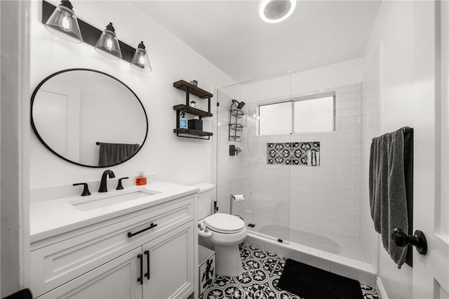 full bath featuring toilet, walk in shower, vanity, and tile patterned floors