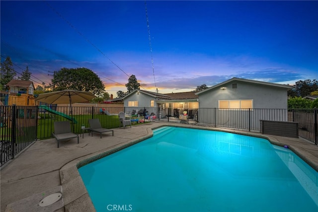 view of swimming pool featuring a fenced in pool, a patio area, a playground, and fence