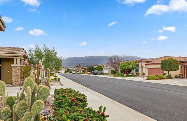 view of road with a residential view and a mountain view