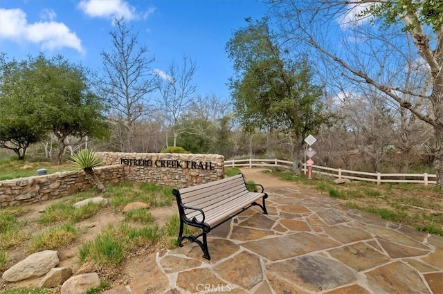 view of property's community featuring a patio area and fence