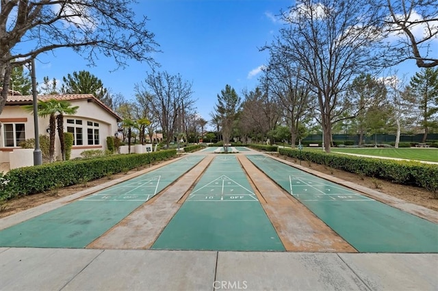 view of property's community featuring shuffleboard