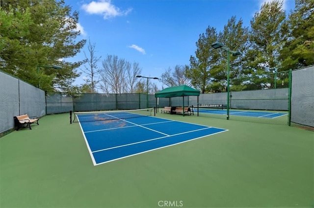 view of sport court with fence