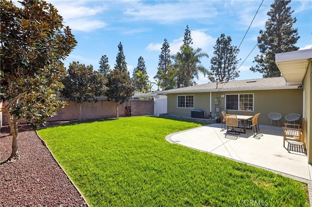 view of yard with cooling unit, a fenced backyard, and a patio