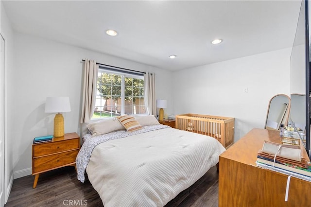 bedroom featuring baseboards, dark wood-style flooring, and recessed lighting