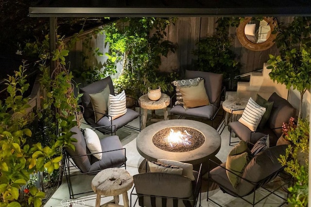 view of patio / terrace with an outdoor living space with a fire pit