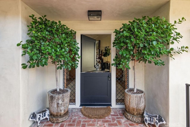 doorway to property with stucco siding